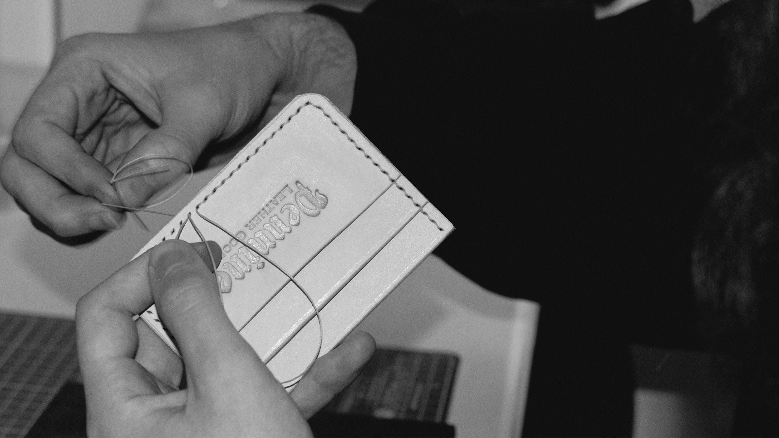 Showing the process of hand stitching leather wallet